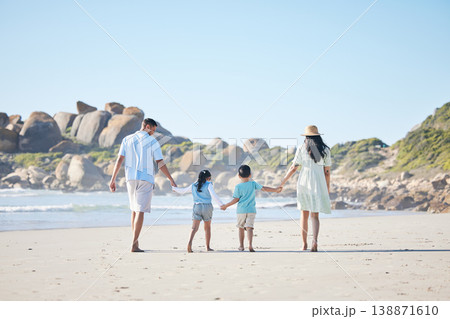 Back, holding hands and a family at the beach for walking, bonding and on a vacation in summer. Care, nature and parents and children with affection while on a walk by the sea during a holiday Back, holding hands and a family at the beach for walking, bonding and on a vacation in summer. Care, nature and parents and children with affection while on a walk by the sea during a holiday 138871610
