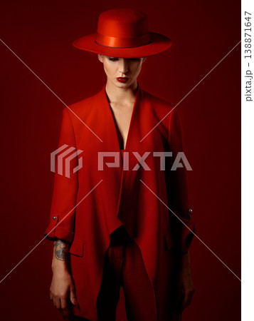 Fashion, suit and hat on woman with beauty in studio with retro, style and edgy, confident or creative pose on red background mockup. Mystery character, model and girl with power or vintage aesthetic Fashion, suit and hat on woman with beauty in studio with retro, style and edgy, confident or creative pose on red background mockup. Mystery character, model and girl with power or vintage aesthetic 138871647