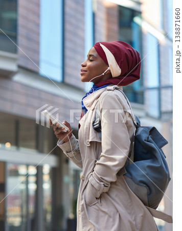 Relax, music and phone with black woman in city for happy and calm, streaming and social media. Technology, internet and radio with muslim girl or student listening to earphones for online podcast 138871660