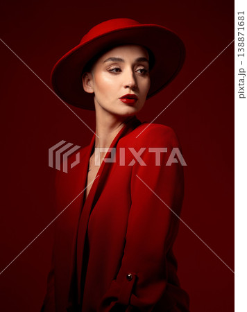 Idea, fashion and woman in red hat in studio isolated on a background with suit. Makeup, cosmetics and female model in fedora, serious style and classy clothes with aesthetic, vision and thinking. Idea, fashion and woman in red hat in studio isolated on a background with suit. Makeup, cosmetics and female model in fedora, serious style and classy clothes with aesthetic, vision and thinking. 138871681