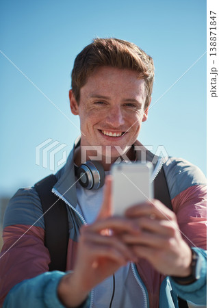 Selfie, travel and man smile outdoor with happiness from travel and freedom by blue sky. Profile picture, social media update and web networking of young person with mobile connection in the sun Selfie, travel and man smile outdoor with happiness from travel and freedom by blue sky. Profile picture, social media update and web networking of young person with mobile connection in the sun 138871847