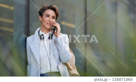 Woman, phone call and communication outdoor, chat and networking with discussion, travel to work and mockup space. Young creative in city, conversation with technology and 5g network in Boston 138871860