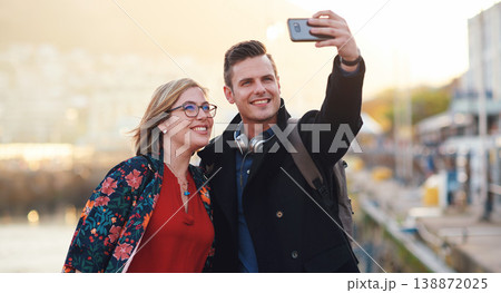 Selfie, travel and couple with phone by harbor enjoying vacation, holiday and honeymoon in Amsterdam. Journey, adventure and happy people take picture for social media, post and memory on smartphone 138872025