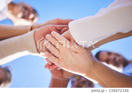 People, hands together and teamwork below in support for trust, bonding or unity and collaboration outdoors. Low angle of family or friends piling hand for team building, community or goals outside People, hands together and teamwork below in support for trust, bonding or unity and collaboration outdoors. Low angle of family or friends piling hand for team building, community or goals outside 138872188