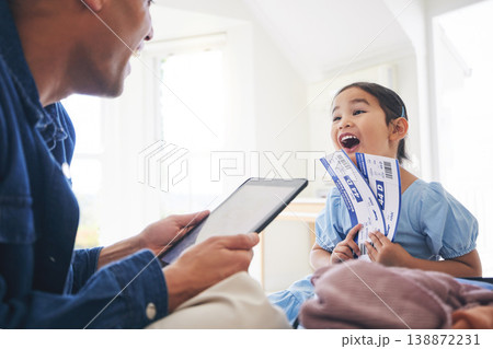 Happy little girl, father and tablet with tickets for travel, vacation or holiday getaway together at home. Dad and excited daughter, child or kid and boarding pass for weekend journey or flight trip Happy little girl, father and tablet with tickets for travel, vacation or holiday getaway together at home. Dad and excited daughter, child or kid and boarding pass for weekend journey or flight trip 138872231