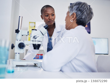 Women, science and discussion of team at microscope for research, medical analysis and biotechnology in laboratory. Black woman listening to scientist for microbiology investigation, dna test or plan Women, science and discussion of team at microscope for research, medical analysis and biotechnology in laboratory. Black woman listening to scientist for microbiology investigation, dna test or plan 138872290