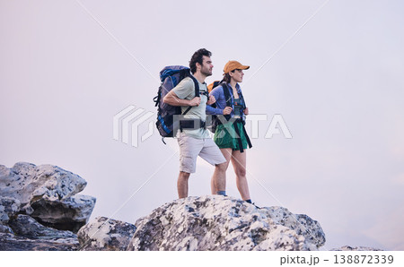 Mountains, hiking and man with woman on cliff for adventure in nature, landscape and travel. Outdoor trekking, couple on peak and relax in scenic clouds for natural journey, walking and rock climbing Mountains, hiking and man with woman on cliff for adventure in nature, landscape and travel. Outdoor trekking, couple on peak and relax in scenic clouds for natural journey, walking and rock climbing 138872339