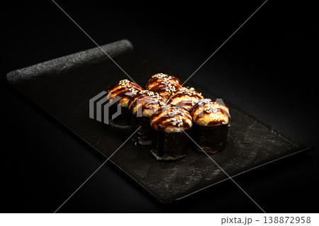 Delicious Fresh Salmon Sushi Rolls Presenting Exquisitely on a Black Background 138872958