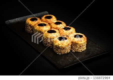 Delicious Fresh Sushi Rolls Presenting Exquisitely on a Black Background Delicious Fresh Sushi Rolls Presenting Exquisitely on a Black Background 138872964