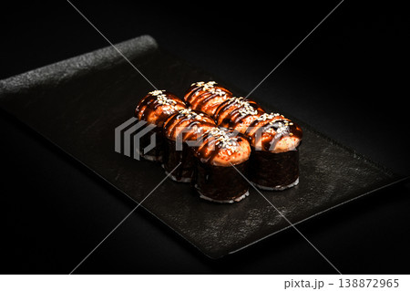 Delicious Fresh Sushi Rolls Presenting Exquisitely on a Black Background Delicious Fresh Sushi Rolls Presenting Exquisitely on a Black Background 138872965