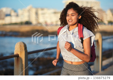 Black woman runner, backpack and sea with smile and summer adventure in city. Gen z and student african girl, happy and young on travel, running and freedom by ocean promenade for fitness Black woman runner, backpack and sea with smile and summer adventure in city. Gen z and student african girl, happy and young on travel, running and freedom by ocean promenade for fitness 138873279