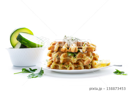 vegetable waffles with zucchini and creamy herb sauce on plate 138873453