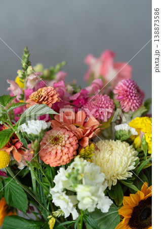 Vibrant mixed bouquet with zinnias, chrysanthemums, and sunflowers Vibrant mixed bouquet with zinnias, chrysanthemums, and sunflowers 138873586