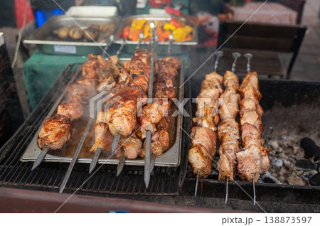 Grilled meat skewers on outdoor barbecue grill 138873597