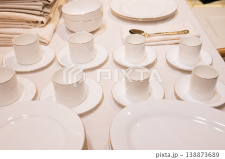 Small porcelain cups placed with saucers on display table Small porcelain cups placed with saucers on display table 138873689