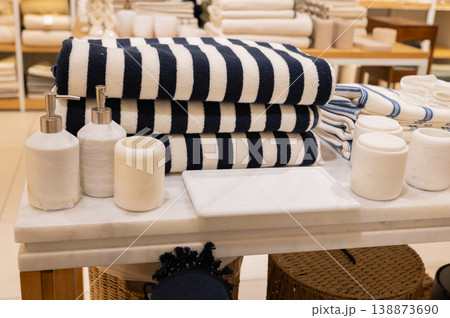 Striped towels stacked with soaps and dispensers on display Striped towels stacked with soaps and dispensers on display 138873690