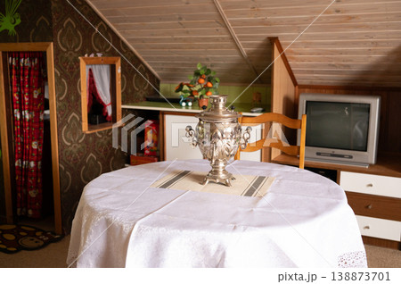 Samovar placed on round table in attic room interior Samovar placed on round table in attic room interior 138873701