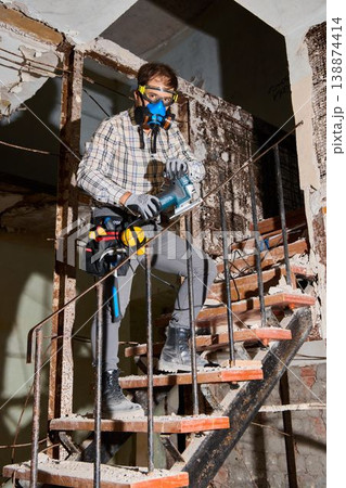 Safety officer evaluates deteriorated steps for potential hazards Safety officer evaluates deteriorated steps for potential hazards 138874414