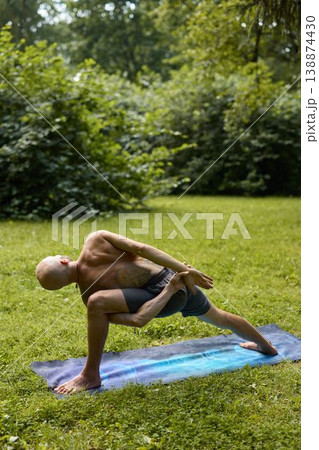 Fitness instructor demonstrating grounded deep hip opening lunge 138874430