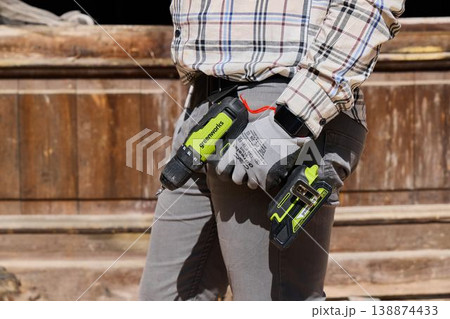 Maintenance person standing with illuminated cordless tools Maintenance person standing with illuminated cordless tools 138874433