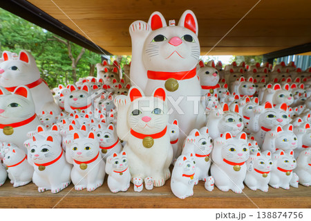 Tokyo, Japan - Sep 30 2024, A close-up view of many multi-sized white beckoning cat figure of Maneki neko with red ears and noses displayed at Gotokuji Temple, without people, at daytime, Tokyo, Japan Tokyo, Japan - Sep 30 2024, A close-up view of many multi-sized white beckoning cat figure of Maneki neko with red ears and noses displayed at Gotokuji Temple, without people, at daytime, Tokyo, Japan 138874756