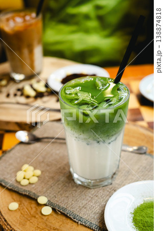Frozen milkshake with matcha tea standing on a wooden table. Frozen milkshake with matcha tea standing on a wooden table. 138874818