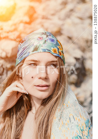 Woman bandana portrait posing in natural sunlight wearing floral headscarf for summer fashion 138875020
