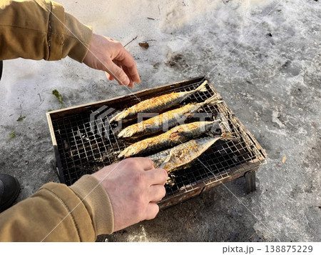 the process of roasting juicy and spiced fresh mackerel on a grill, mackerel on coals on a grill recipe 138875229