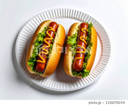 Easy meal. Two grilled hot dog in fresh bun, topped with zigzag lines of mustard on a plate. Top view. 138876034