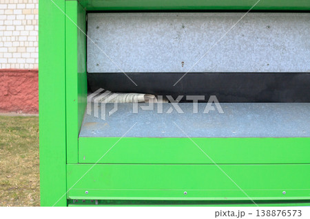 Trash container for collecting street paper waste close-up. Waste recycling and an eco-friendly approach in the urban environment. 138876573