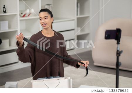Fashion vlogger showing new fashionable stuff to her subscribers in social media Fashion vlogger showing new fashionable stuff to her subscribers in social media 138876623