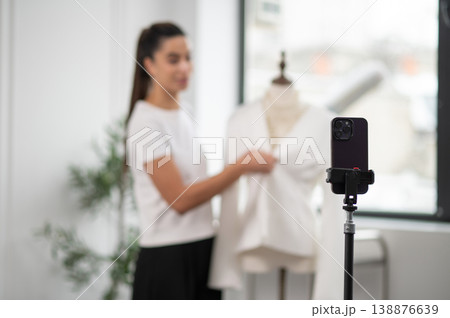 Modern fashion designer presenting new clothes collection during live translation Modern fashion designer presenting new clothes collection during live translation 138876639