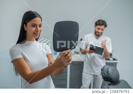 Long-haired young woman at the appointment in the dental clinic Long-haired young woman at the appointment in the dental clinic 138876701