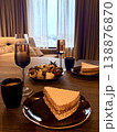 Romantic dessert setting in a hotel room with champagne, chocolate strawberries and wafer cake. 138876870