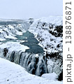 Close-up vertical shot of Gullfoss waterfall in Iceland during winter with ice and rushing water. 138876871