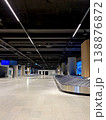 Modern empty airport baggage claim area with conveyor belts and digital screens. 138876872