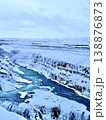Stunning winter landscape of a frozen canyon river with snow-covered rocks and waterfall. 138876873