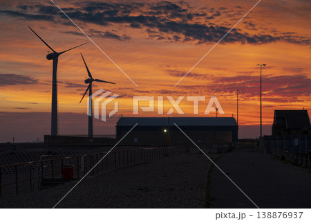 Wind turbines and port buildings at Shoreham Port at dusk 138876937