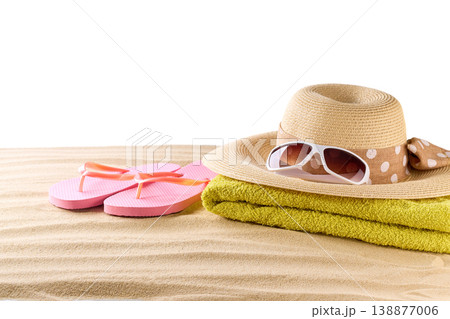 pink flip flops with straw beach hat and sunglasses on a beach sand, isolated on a white background. pink flip flops with straw beach hat and sunglasses on a beach sand, isolated on a white background. 138877006