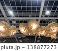 Bright lights hang from the ceiling in a modern space with unique designs and shapes 138877273