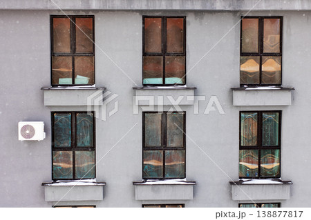 Charming winter evening with softly lit windows revealing inviting domestic tranquility Charming winter evening with softly lit windows revealing inviting domestic tranquility 138877817