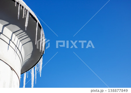 Frozen urban scene. Minimalist shot of icy structure with sharp shadows and frozen droplets Frozen urban scene. Minimalist shot of icy structure with sharp shadows and frozen droplets 138877849