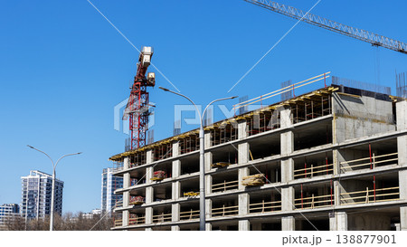 Building framework under clear sky. Construction area showing steel and scaffolding details Building framework under clear sky. Construction area showing steel and scaffolding details 138877901
