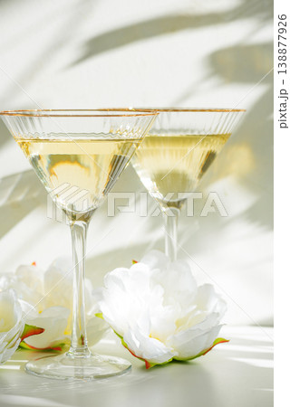 Champagne Glasses with White Peonies. Birthday or Wedding Celebration Arrangement 138877926