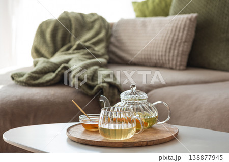 Glass Teapot with Citrus Green Tea and Honey on White Table in Cozy Living Room Glass Teapot with Citrus Green Tea and Honey on White Table in Cozy Living Room 138877945
