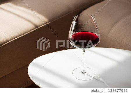 Red Wine Glass on White Table in Cozy Living Room Red Wine Glass on White Table in Cozy Living Room 138877951