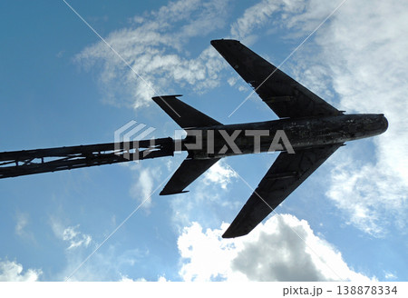 Old military plane monument on blue sky background Old military plane monument on blue sky background 138878334