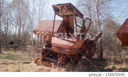 Rusty Harvester In Belarus Exclusion Zone, Overgrown Field And Saplings Reclaim Corroded Body, Peeling Paint, 138878395