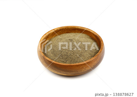 Ground black pepper spice in a wooden bowl isolated on white background. Top view, close-up 138878627