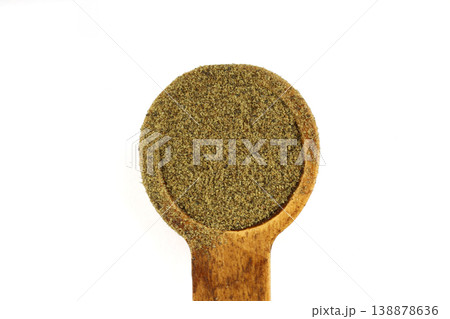 Macro of ground black pepper in wooden spoon isolated on white background. Top view, spice texture 138878636